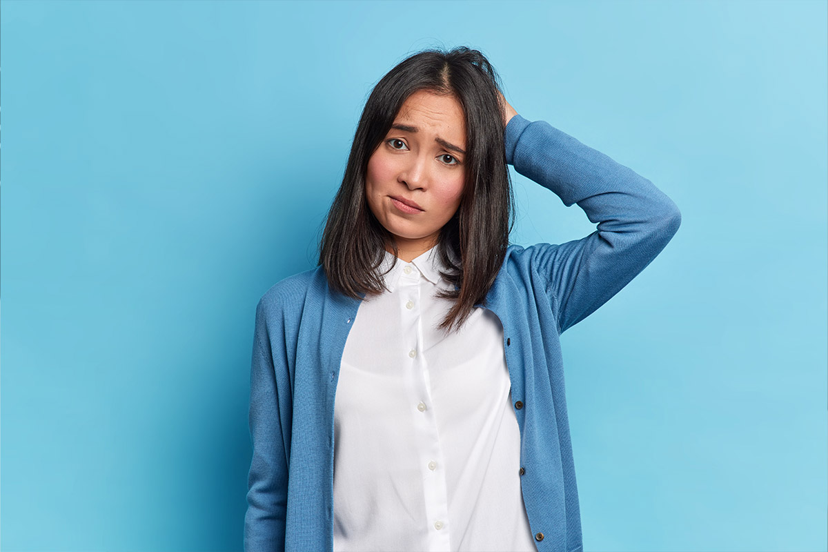 Woman looking uncertain, representing the challenge of responding to negative patient reviews in orthopedic practice management