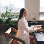 Smiling professional working on a laptop, representing orthopedic SEO strategies to improve Google rankings in 2024.